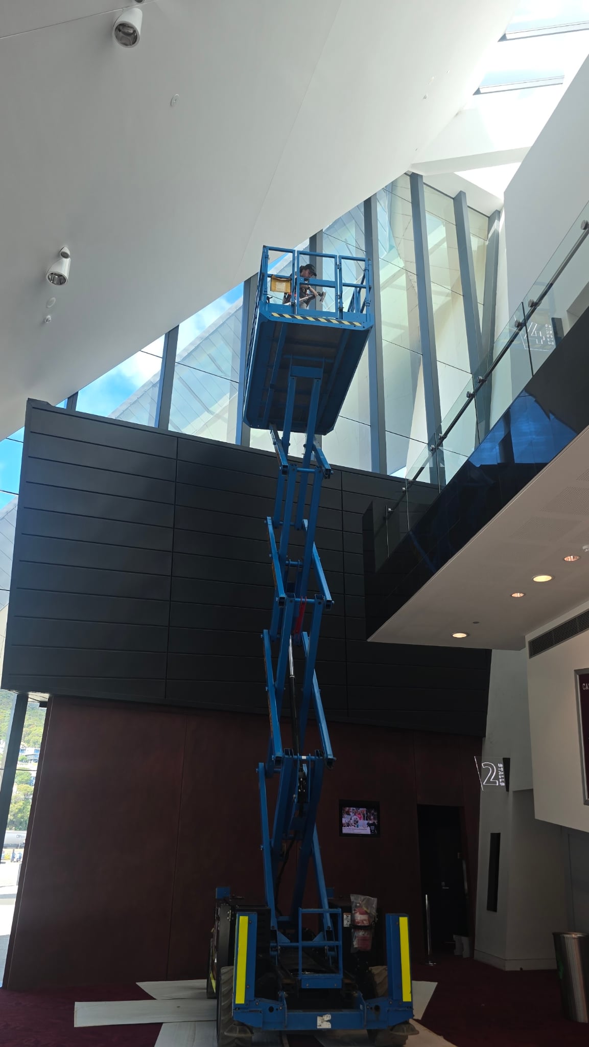 Cleaning walls in an elevated work platform